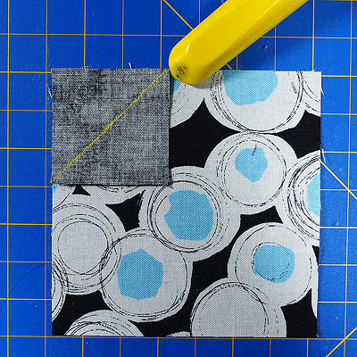 circle fabric with black square wrong side down in corner and a yellow chalk line