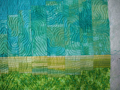lime green fabric, yellow blending section and turquoise sky all free motion quilted