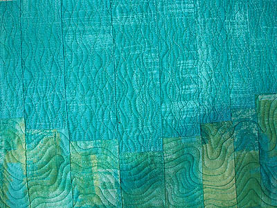 dark turquoise fabric with vertical curvy lines forming a mesh like appearance on the background