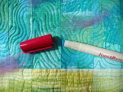 glue marker open showing narrow blue glue applicator on turquoise background