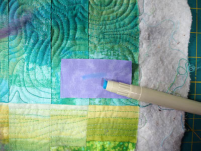 blue glue line on purple fabric that will dry clear