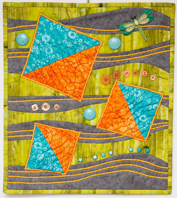 Improv Design Quilt with teal and orange kite shapes