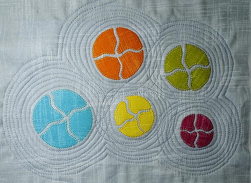 Echo quilting completed with free motion stitching in grey thread