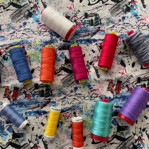Many spools of thread on fabric