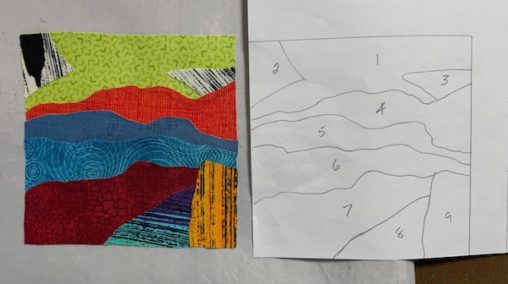 multiple fabric block beside a piece of paper with pencil lines