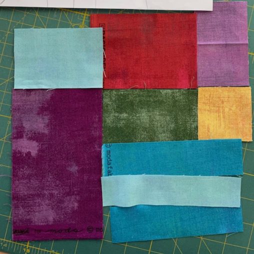 Many pieces of colourful fabric squares and rectangles