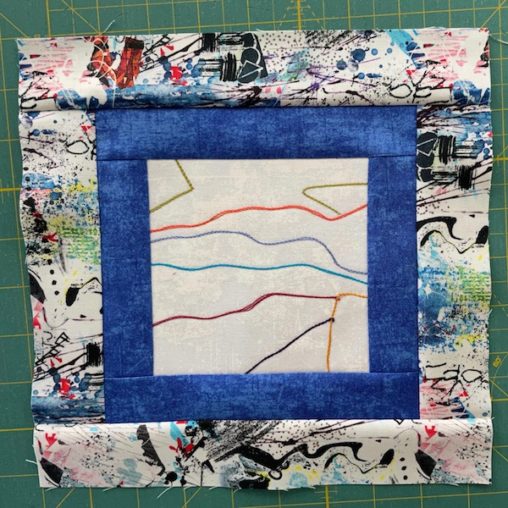 multi coloured fabric frames a blue and white block