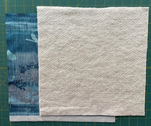 teal fabric under beige backing