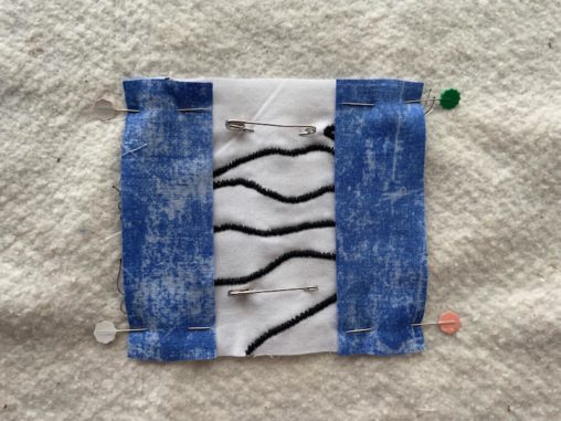 blue rectangles pinned on white square