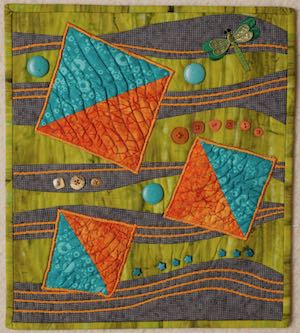 orange and teal squares on an art quilt