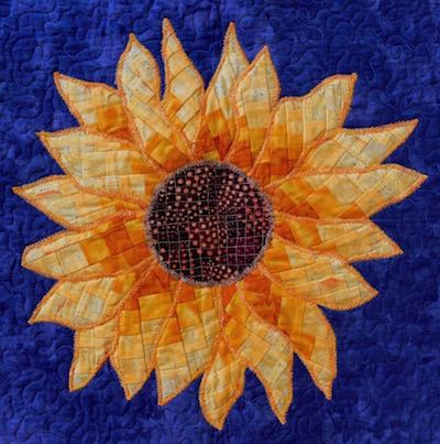 yellow orange bargello sunflower on medium blue background