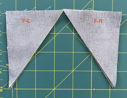 Labelled grey triangles on a cutting mat