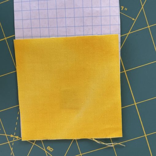 Graph paper and yellow fabric