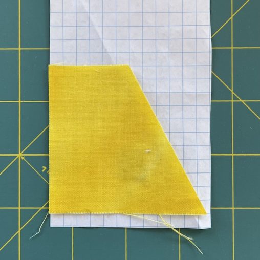 Diagonal cut off yellow fabric on graph paper
