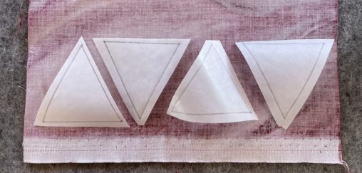4 white triangles on the wrong side of red fabric