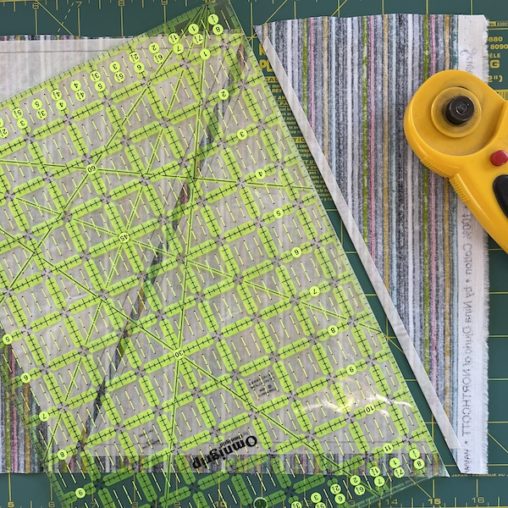 ruler, fabric and rotary cutter