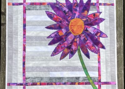 grey background with purple and orange flower