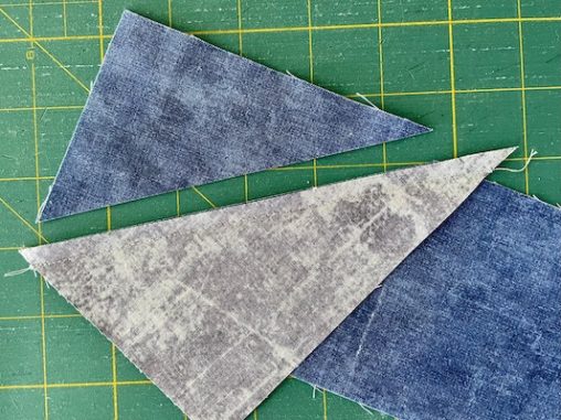 blue triangle cut away from grey triangle and blue rectangle