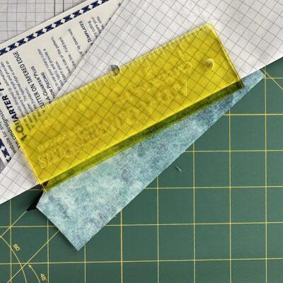 yellow ruler with paper and teal fabric