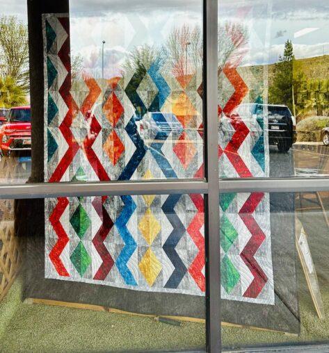 colourful quilt in a window