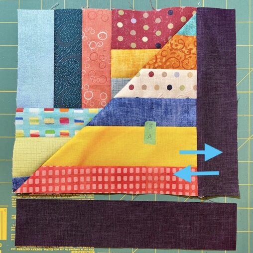 colour strip pieced block with dark coloured sashing